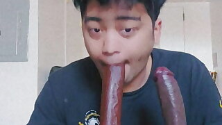 Latino Femboy sucks 2 big black dildos
